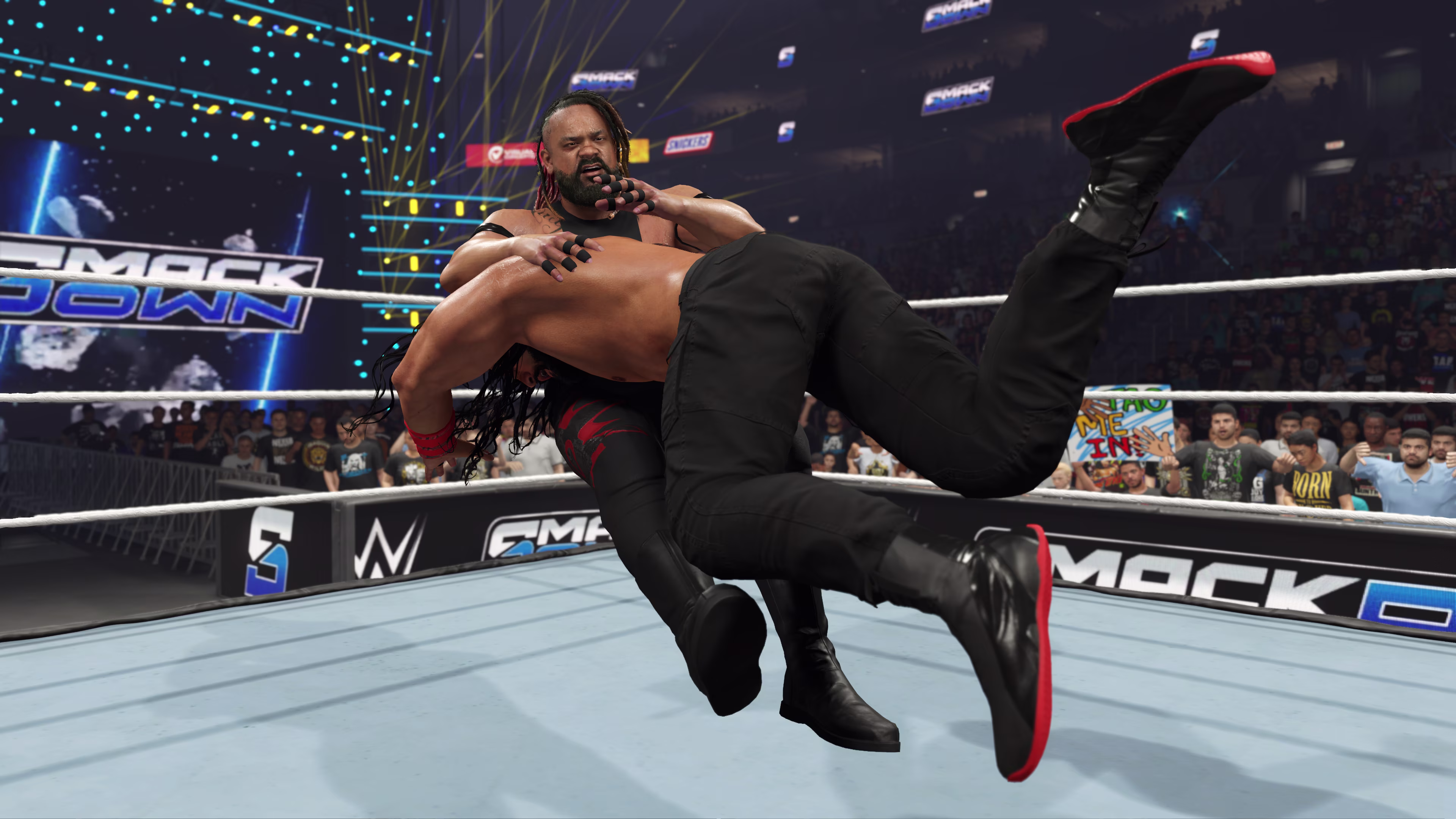 Roman Reigns spears Jacob Fatu on Friday Night SmackDown in WWE 2K25